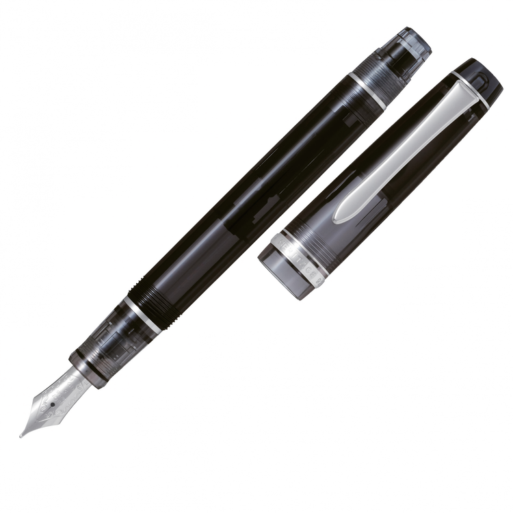 a piston filler fountain pen, transparent black with silver trim and flat ends