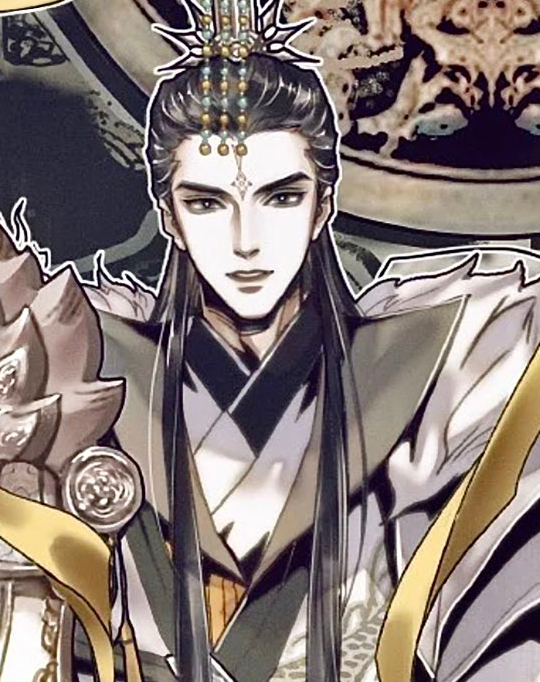 a smiling guy with a fancy headpiece and huge white and gold robes