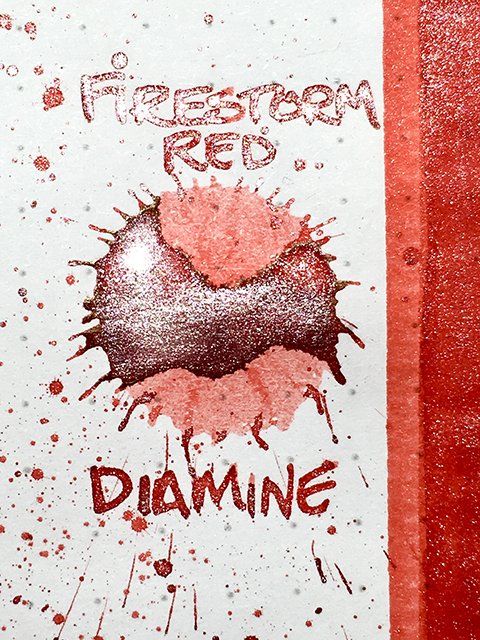 red ink splat with silver shimmer