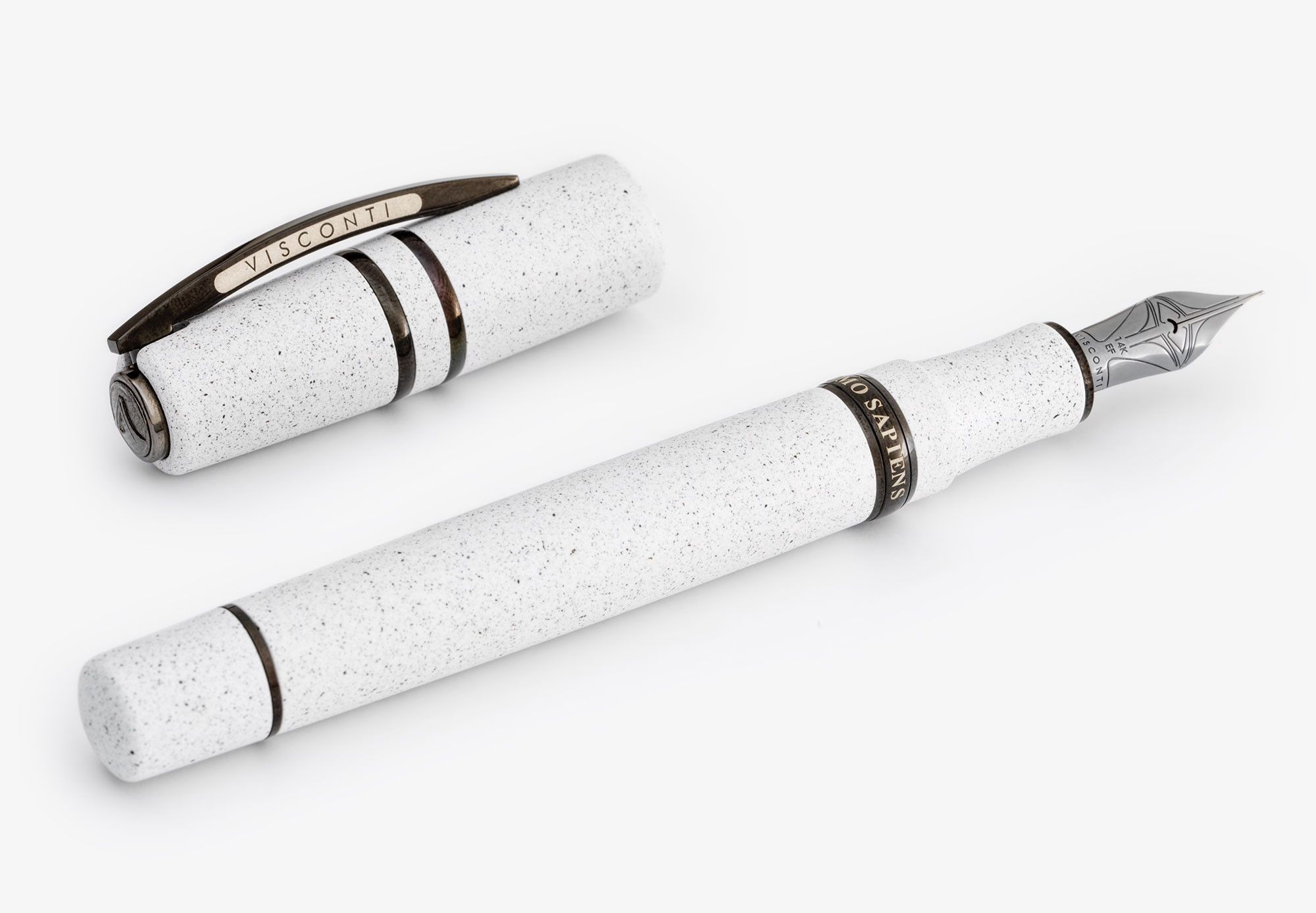 a pen made of white stone with subtle black speckles, a heavy clip and dark metal trim