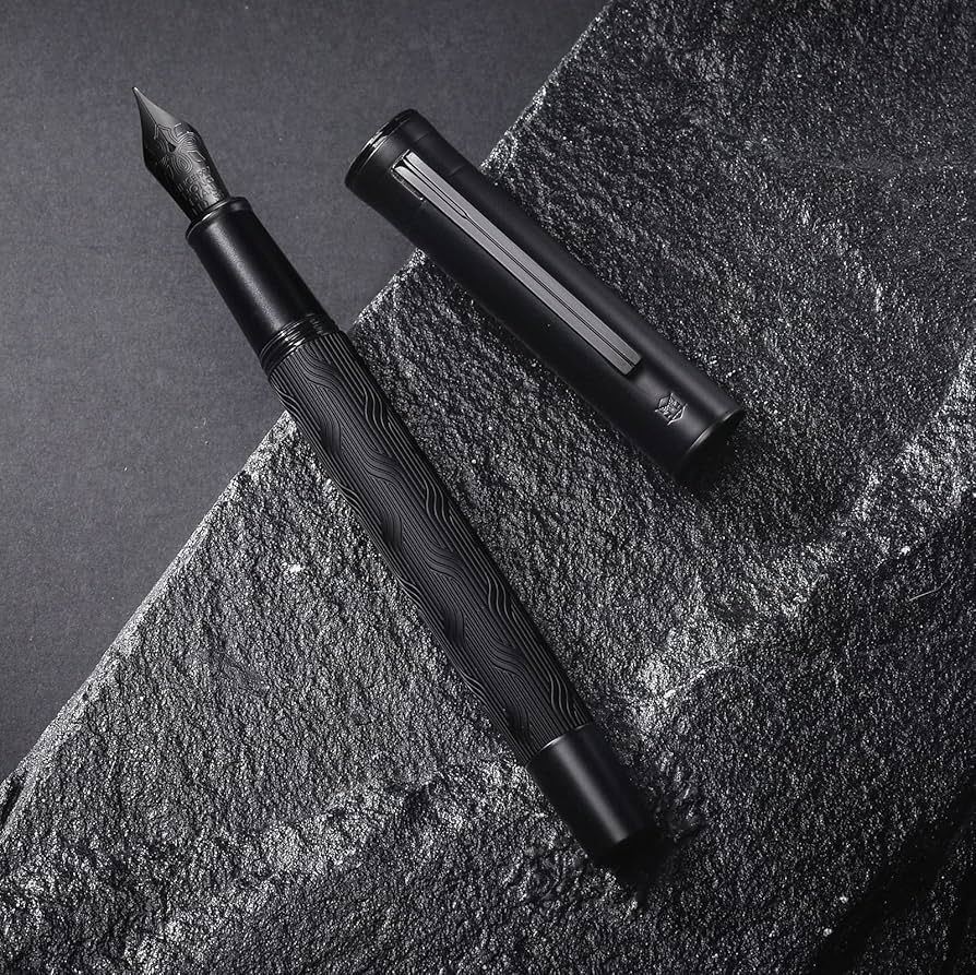 An all black fountain pen with a pattern of interweaving lines on the barrel