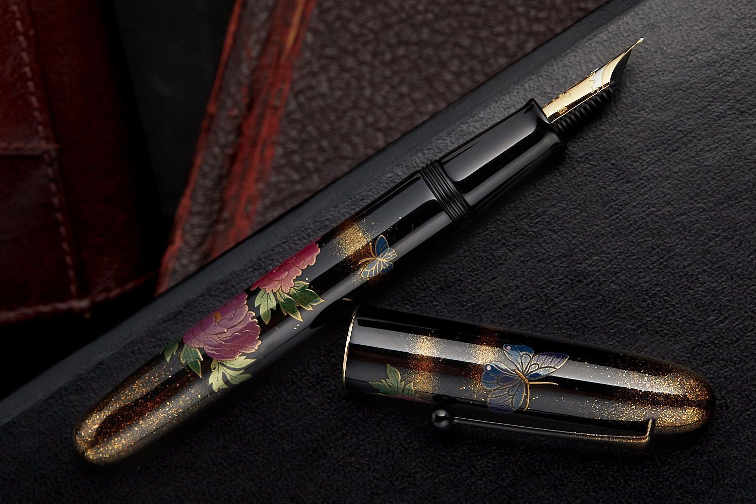 Fountain pen with designs of flowers, butterflies and gold sparkles